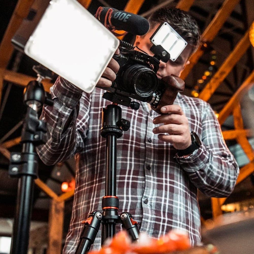 Louis Hopkins filming with a camera rig and lights
