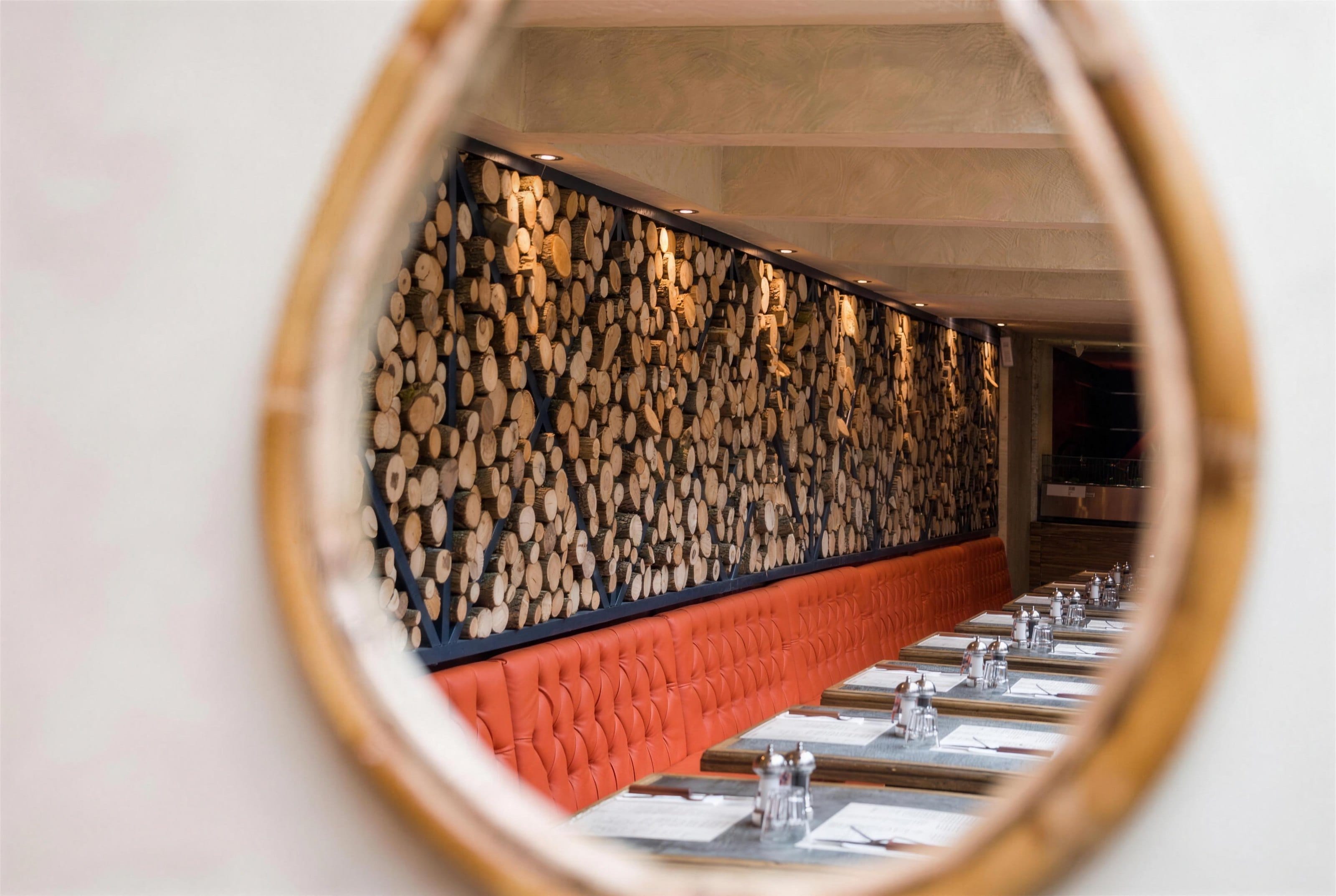 A dining room reflected in a round mirror